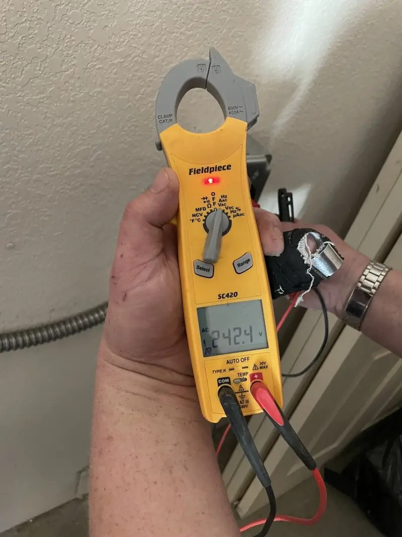 Voltage testing with clamp meter during Whole House Surge Protector in Groveton